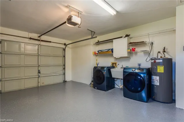 a utility room with cabinets dryer and washer