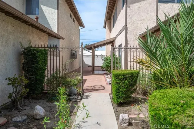a view of a pathway both side of house