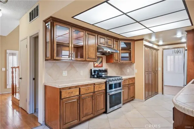 a kitchen with stainless steel appliances granite countertop a stove and a refrigerator