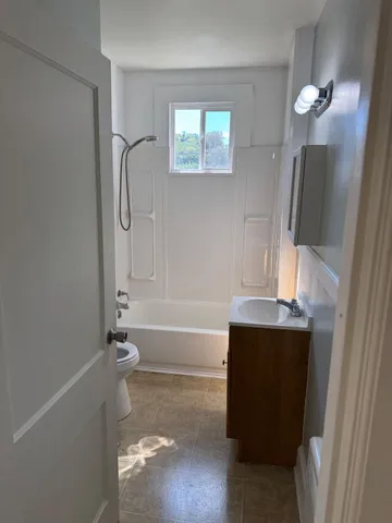 a bathroom with a bathtub a sink and mirror