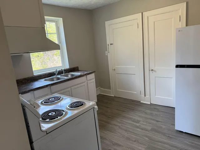 a view of kitchen appliances and wooden floor