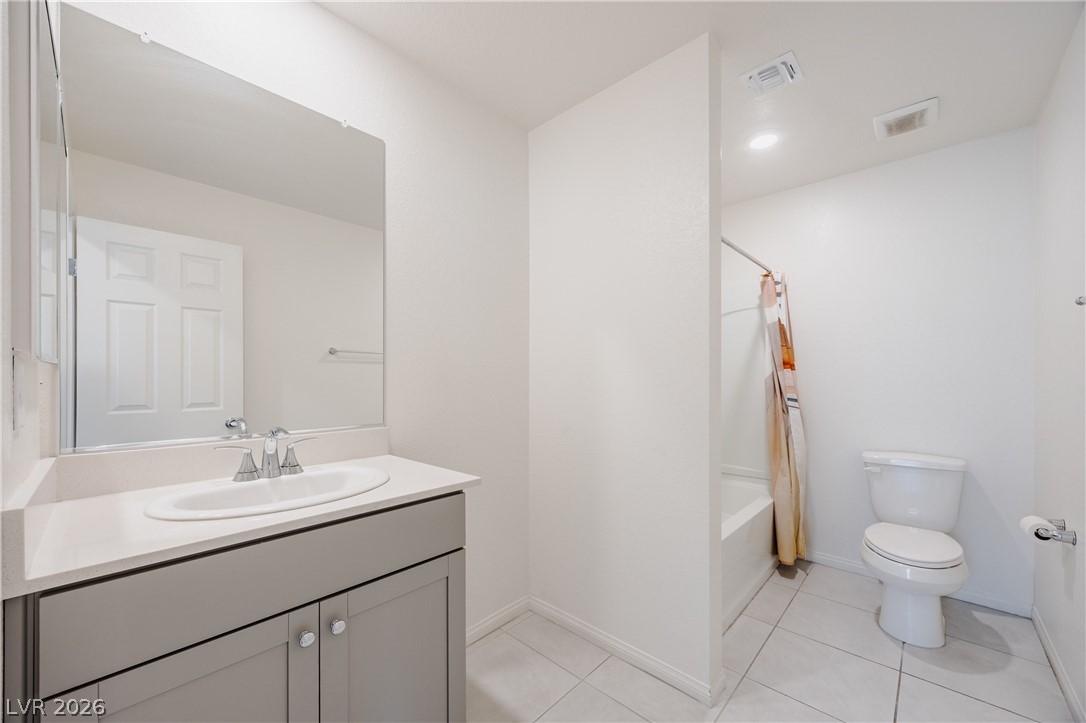 5927 Coja Street Las Vegas, NV 89113 - Photo 20 of 32 Bathroom with vanity, toilet, baseboards, and shower / bath combo