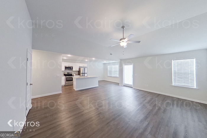 205 Redwood Court Springfield, GA 31329 - Photo 3 of 13 a view of an empty room with window and wooden floor