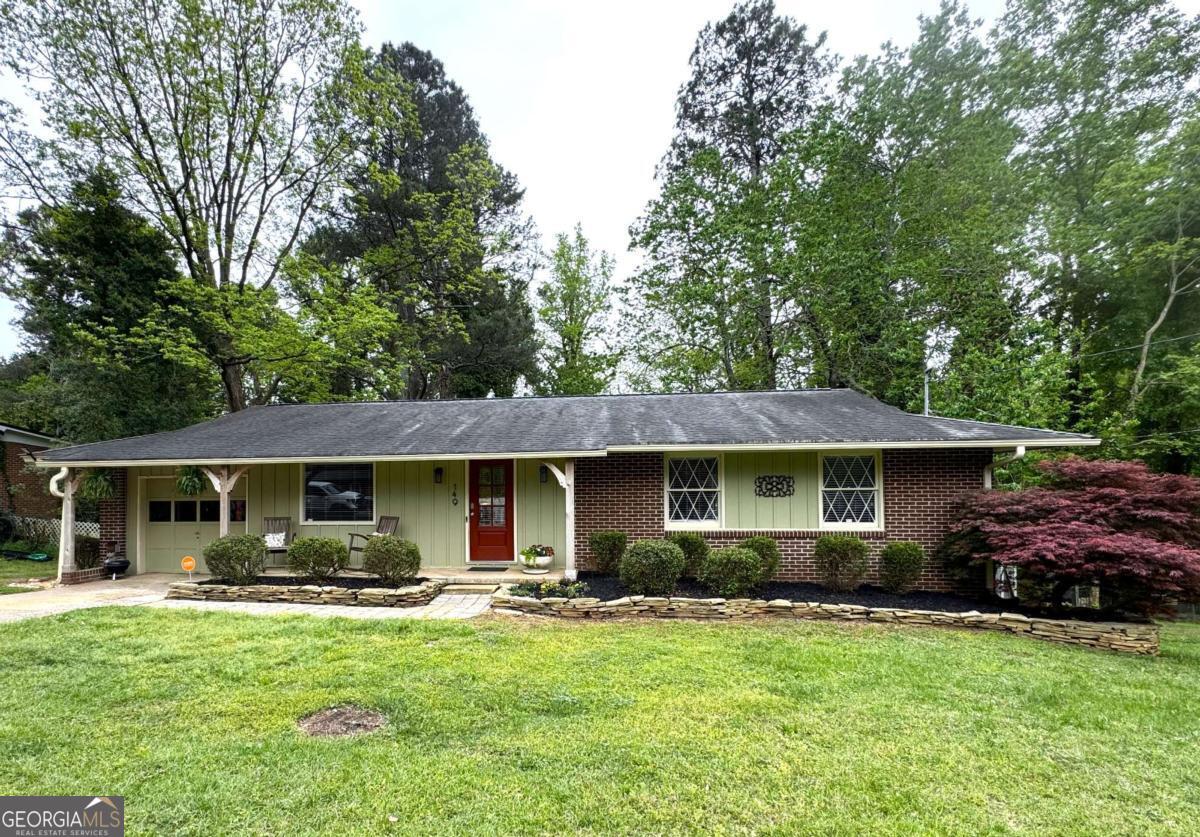 149 Caroline Avenue Athens, GA 30606 - Photo 1 of 42 a front view of a house with a garden