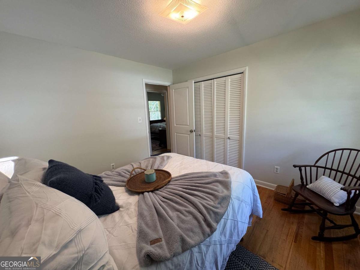 149 Caroline Avenue Athens, GA 30606 - Photo 14 of 42 a bedroom with a bed and wooden floor