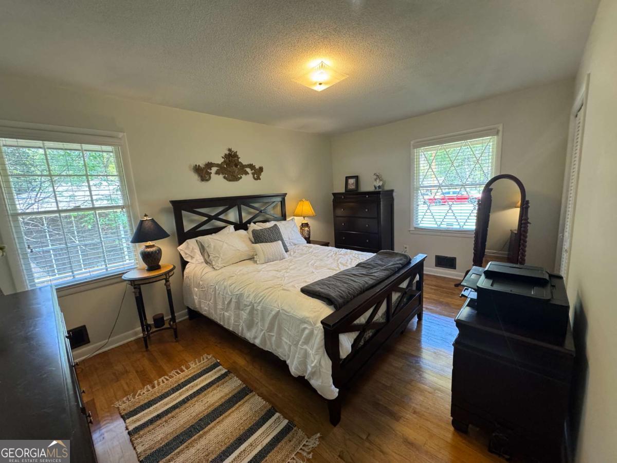 149 Caroline Avenue Athens, GA 30606 - Photo 15 of 42 a bedroom with a bed and wooden floor