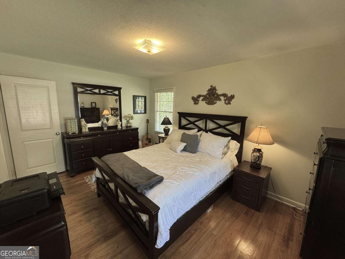 149 Caroline Avenue Athens, GA 30606 - Photo 16 of 42 a bedroom with a bed and wooden floor