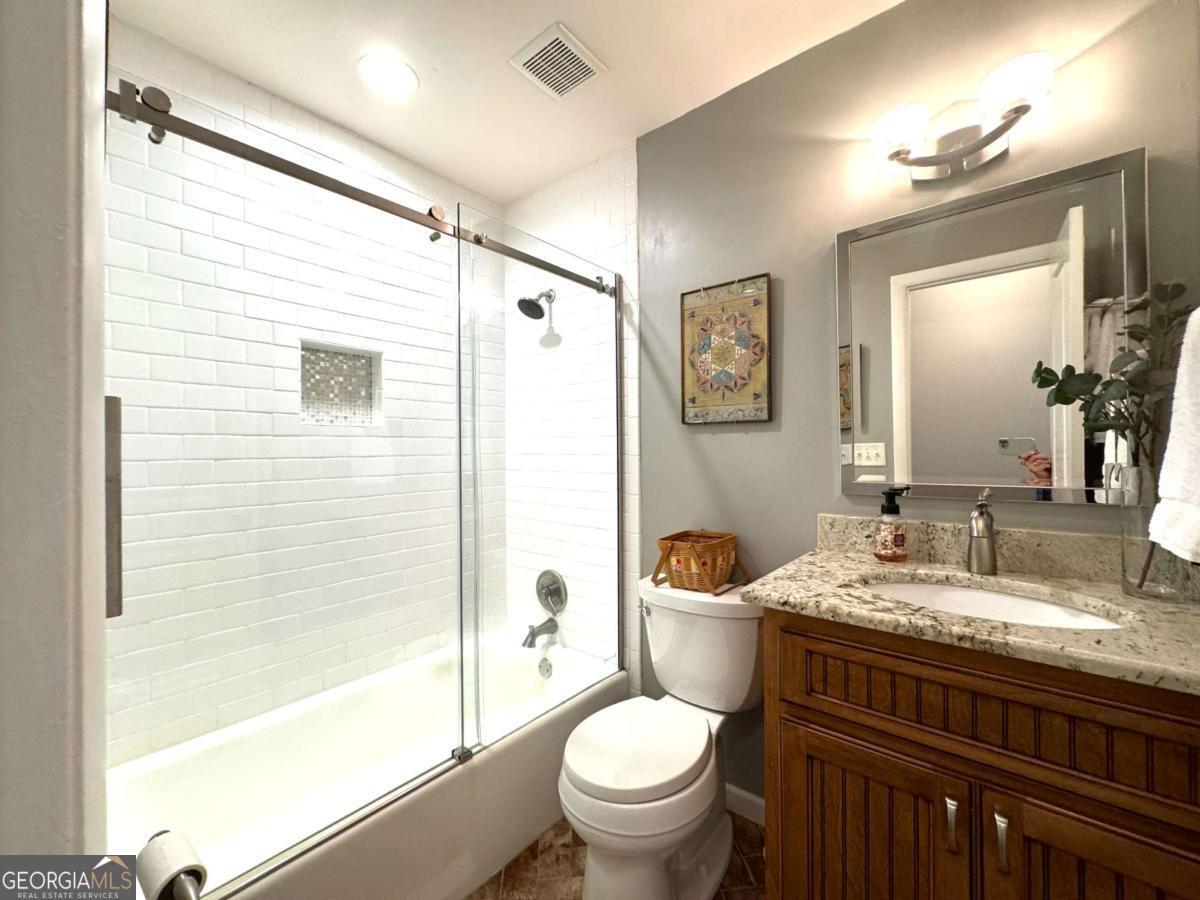 149 Caroline Avenue Athens, GA 30606 - Photo 19 of 42 a bathroom with a granite countertop sink toilet and shower
