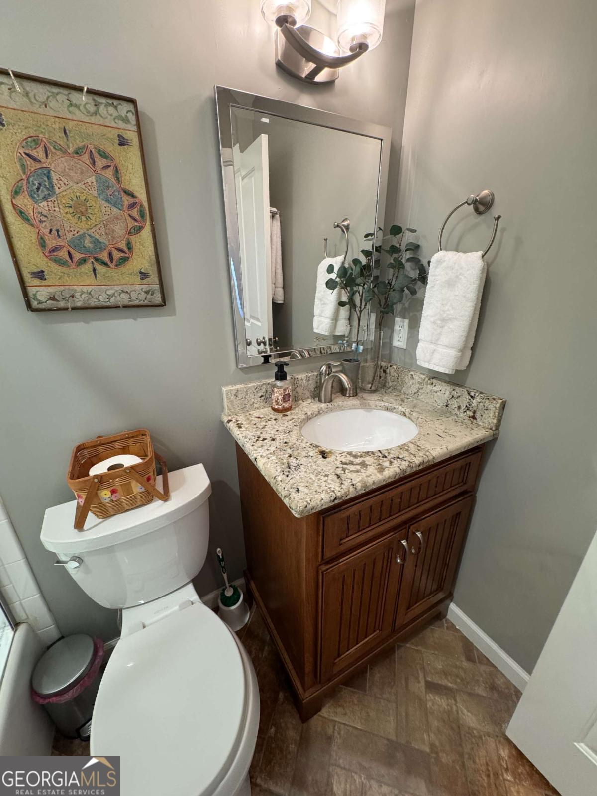 149 Caroline Avenue Athens, GA 30606 - Photo 20 of 42 a bathroom with a granite countertop toilet sink and mirror