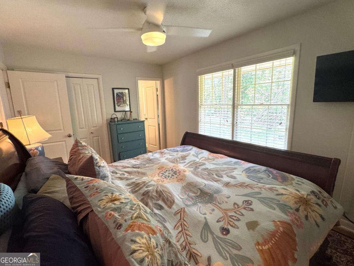 149 Caroline Avenue Athens, GA 30606 - Photo 22 of 42 a bed sitting in a bedroom next to a window
