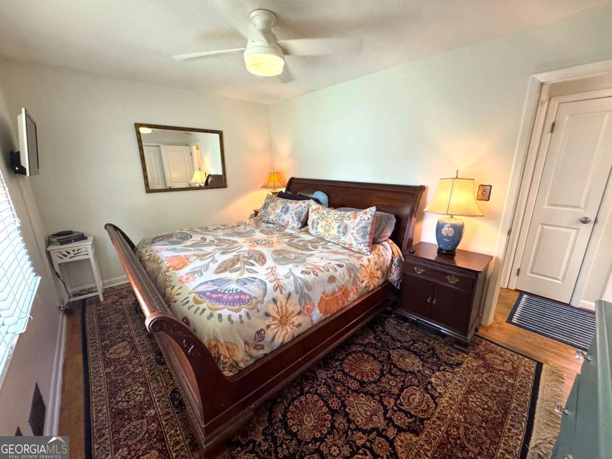 149 Caroline Avenue Athens, GA 30606 - Photo 24 of 42 a bed sitting in a bedroom next to a window with pc on the table