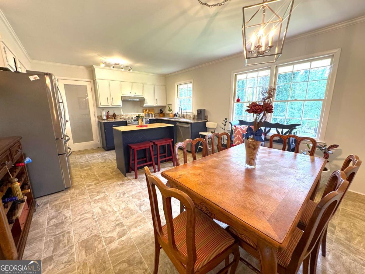 149 Caroline Avenue Athens, GA 30606 - Photo 6 of 42 a dining room with a table chairs and a refrigerator
