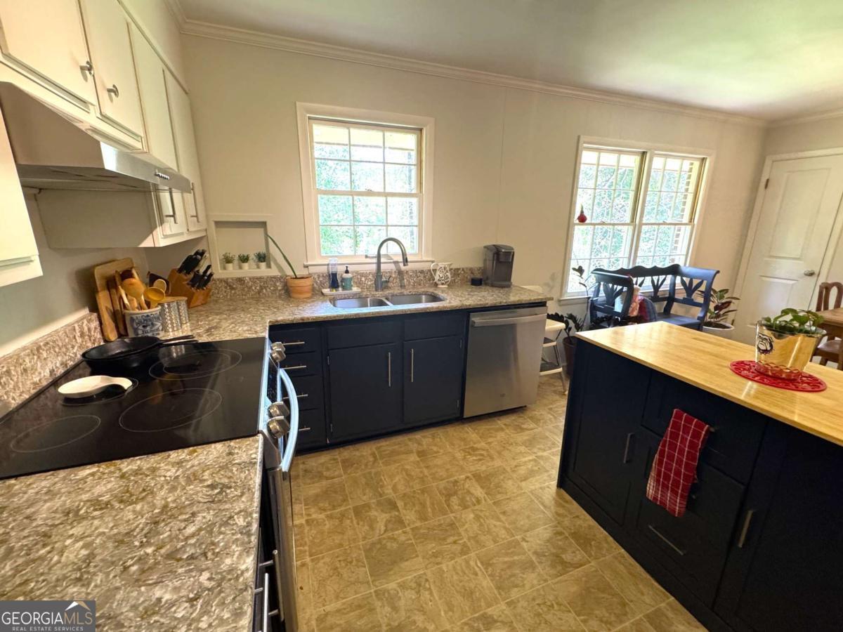 149 Caroline Avenue Athens, GA 30606 - Photo 10 of 42 a kitchen with a stove a sink and a refrigerator