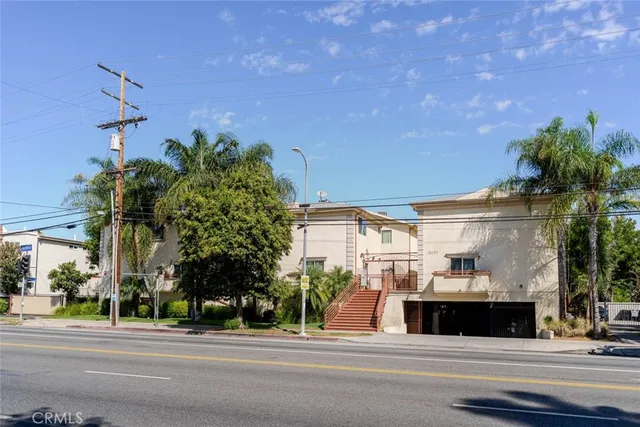 a view of street along with house and trees