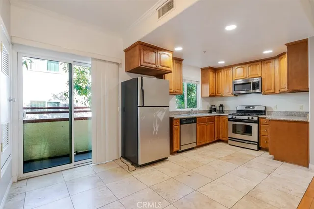 a kitchen with stainless steel appliances granite countertop a sink stove and cabinets