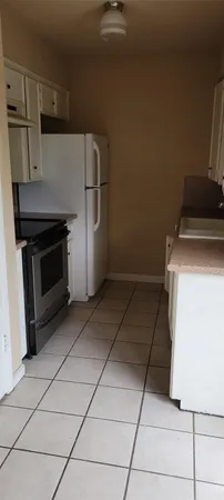 a kitchen with a stove and a refrigerator