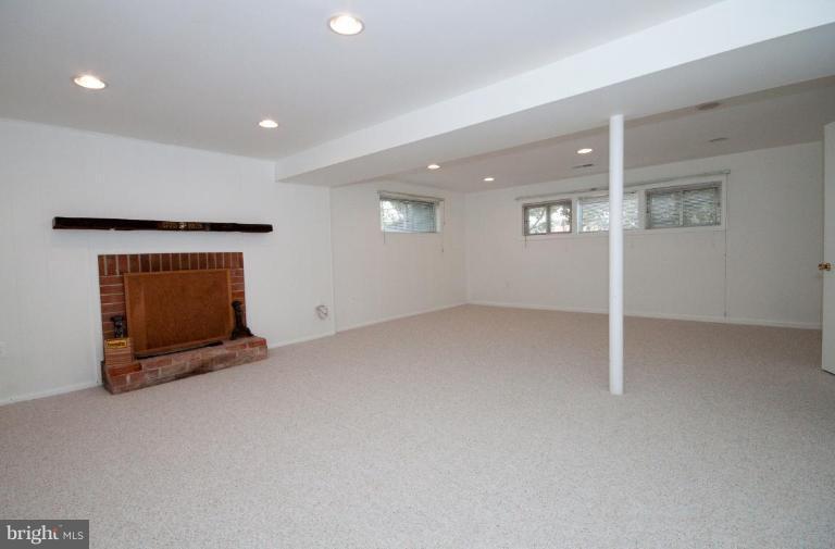 5510 Callander Drive Springfield, VA 22151 - Photo 14 of 17 a view of an empty room with wooden floor and a fireplace