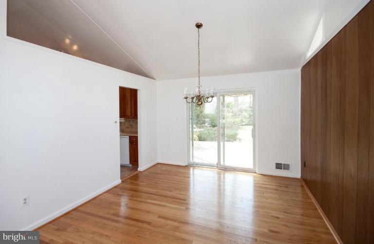5510 Callander Drive Springfield, VA 22151 - Photo 5 of 17 a view of an empty room with wooden floor and a window
