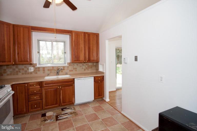5510 Callander Drive Springfield, VA 22151 - Photo 6 of 17 a kitchen with a sink window and cabinets