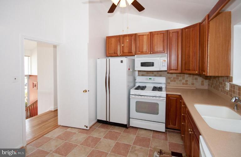 5510 Callander Drive Springfield, VA 22151 - Photo 7 of 17 a kitchen with stainless steel appliances granite countertop a refrigerator sink and stove
