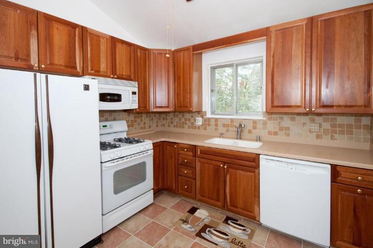 5510 Callander Drive Springfield, VA 22151 - Photo 8 of 17 a kitchen with stainless steel appliances granite countertop a refrigerator sink and cabinets