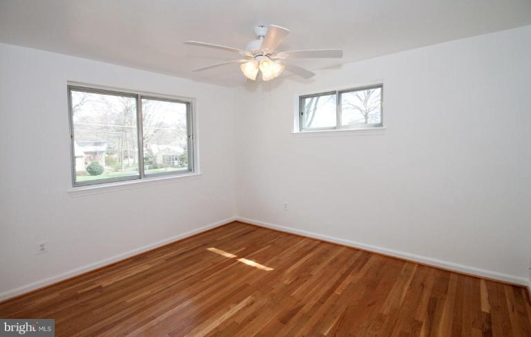 5510 Callander Drive Springfield, VA 22151 - Photo 10 of 17 a view of an empty room with wooden floor and a window
