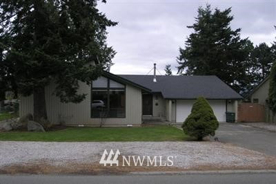 3718 Magrath Road Bellingham, WA 98226 - Photo 1 of 1 a front view of a house with a garden