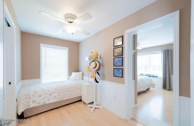 a bedroom with a bed and ceiling fan