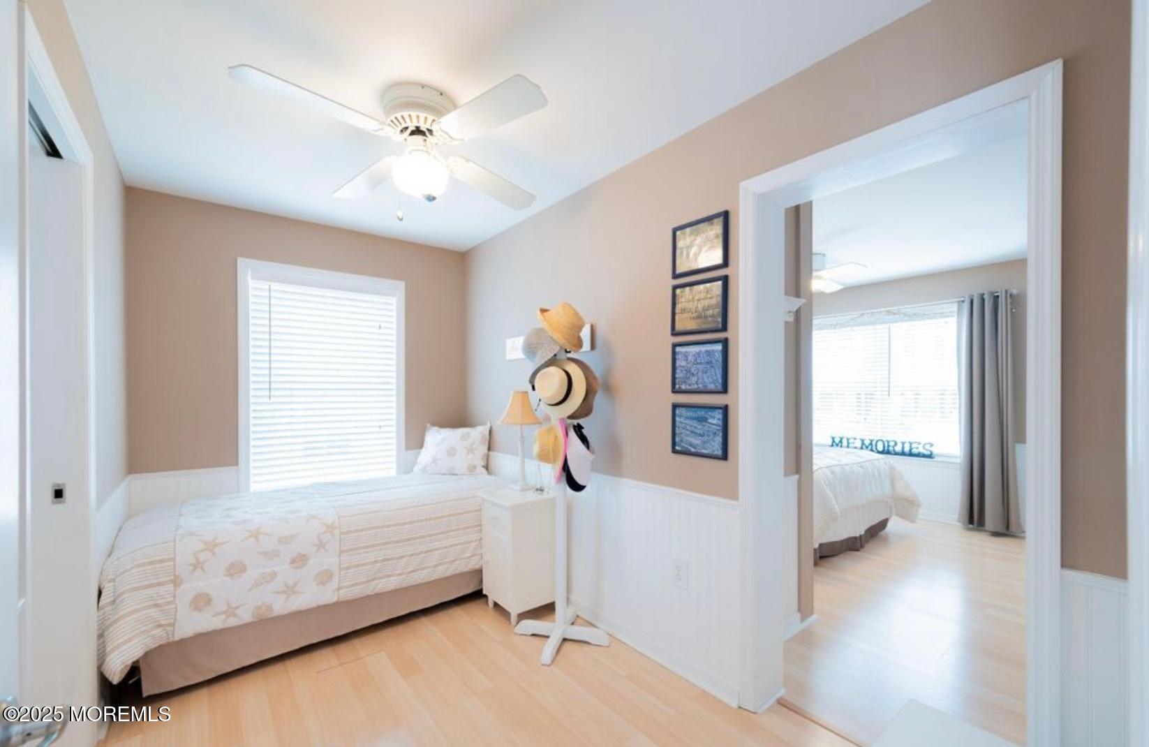 136 Joseph Street Lavallette, NJ 08735 - Photo 12 of 24 a bedroom with a bed and ceiling fan