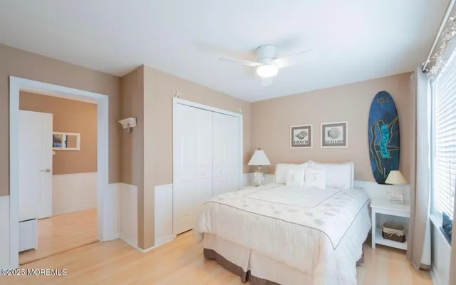 a bedroom with a large bed and a chandelier