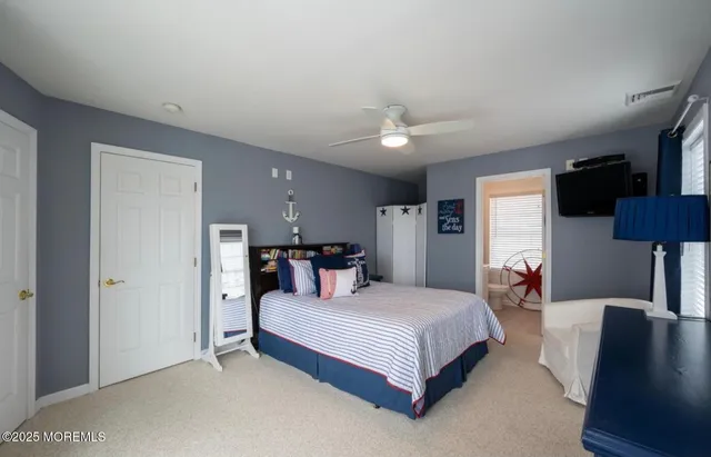 a bedroom with a bed couch and a window