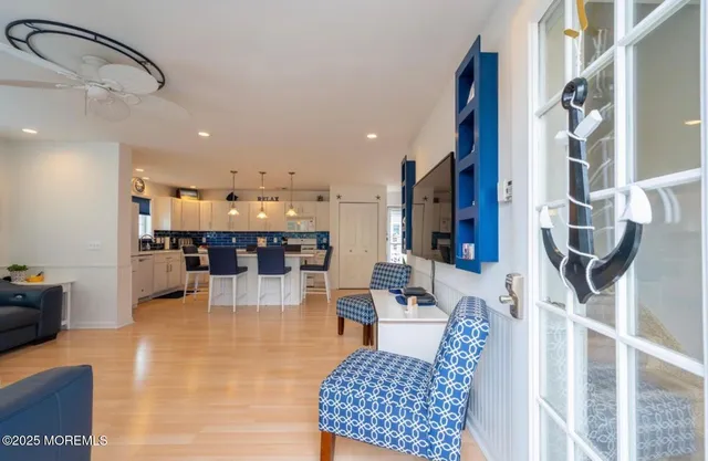 a living room with lots of furniture and kitchen view