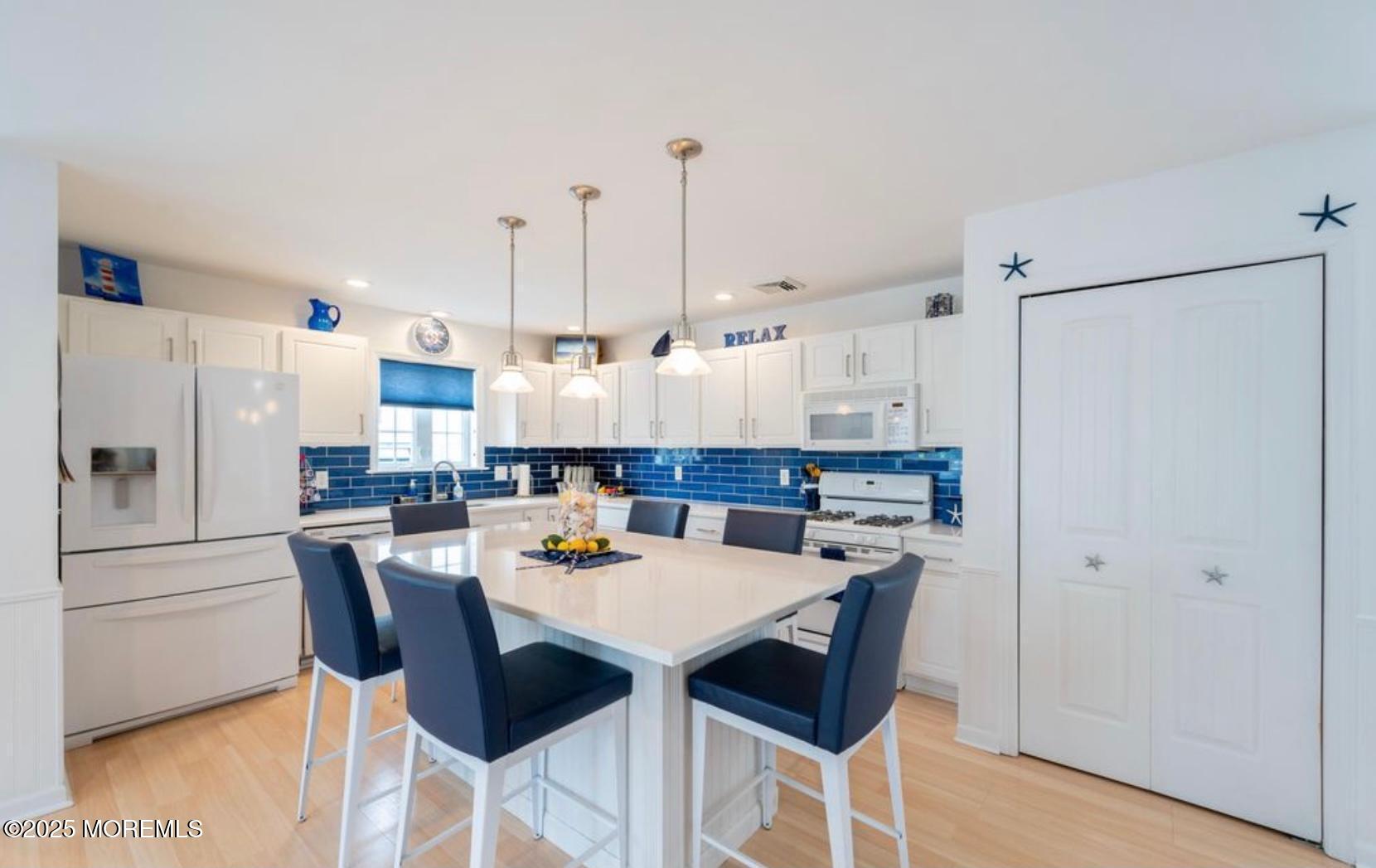 136 Joseph Street Lavallette, NJ 08735 - Photo 8 of 24 a kitchen with refrigerator and chairs