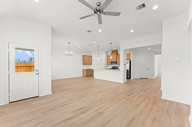 a view of a kitchen with a sink and a refrigerator