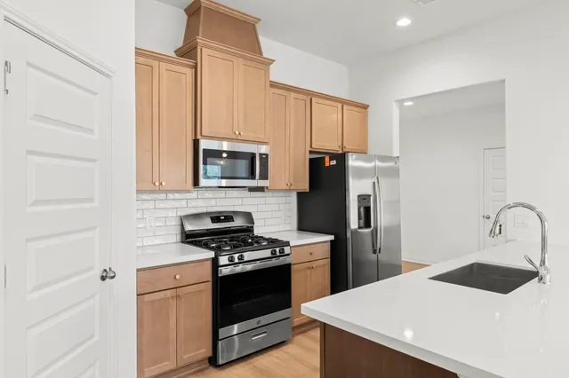 a kitchen with a sink a stove and refrigerator