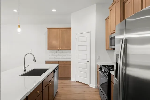 a kitchen with a refrigerator and a sink