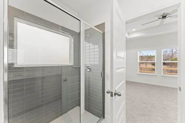 a bathroom with a shower and a window