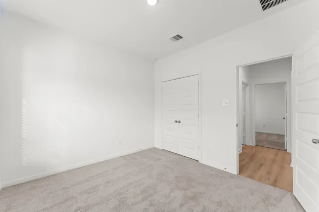 a view of a big room with closet and wooden door