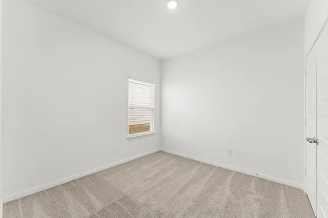 a view of an empty room and a window