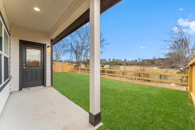 a very nice looking house with a big yard and large trees