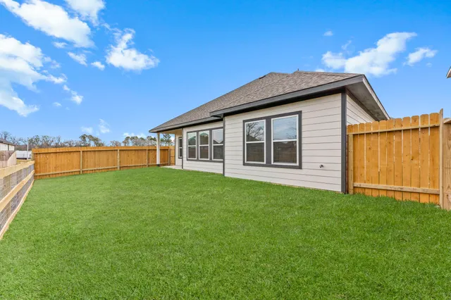 a view of a house with a backyard
