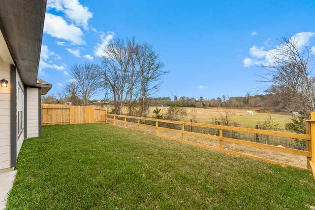 a view of yard with swimming pool and trees