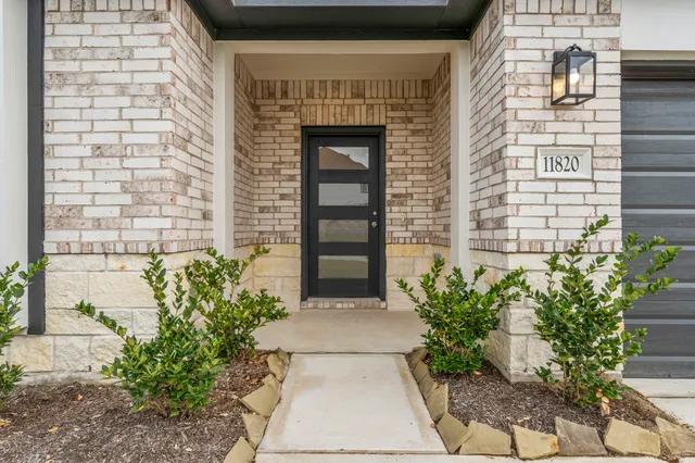 a front view of a house with potted plants