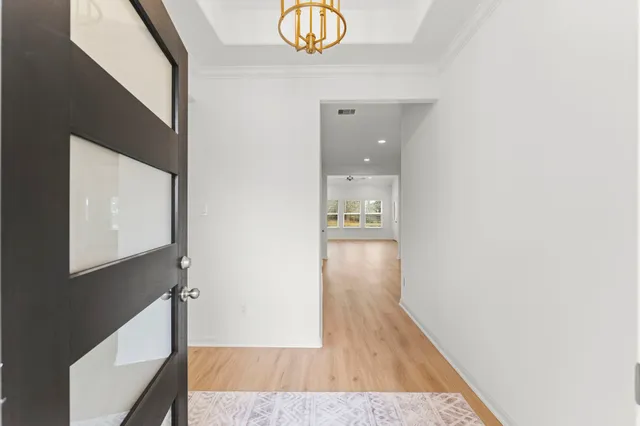 a view of hallway with wooden floor