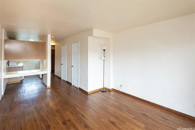 a view of a room with wooden floor
