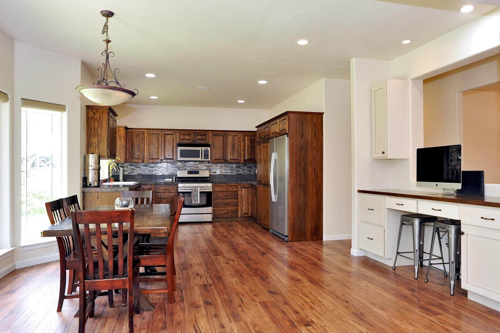 19834 Powers Road Bend, OR 97702 - Photo 4 of 22 Wide open living space to entertain family & friends. Features engineered wood floors, high ceilings, stainless appliances, surround sound, picture windows overlooking back yard, plus a built-in work station.