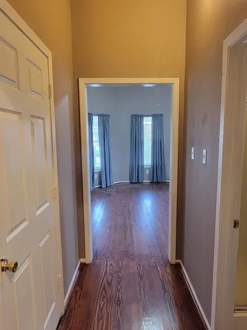 a kitchen with a sink cabinets and wooden floor
