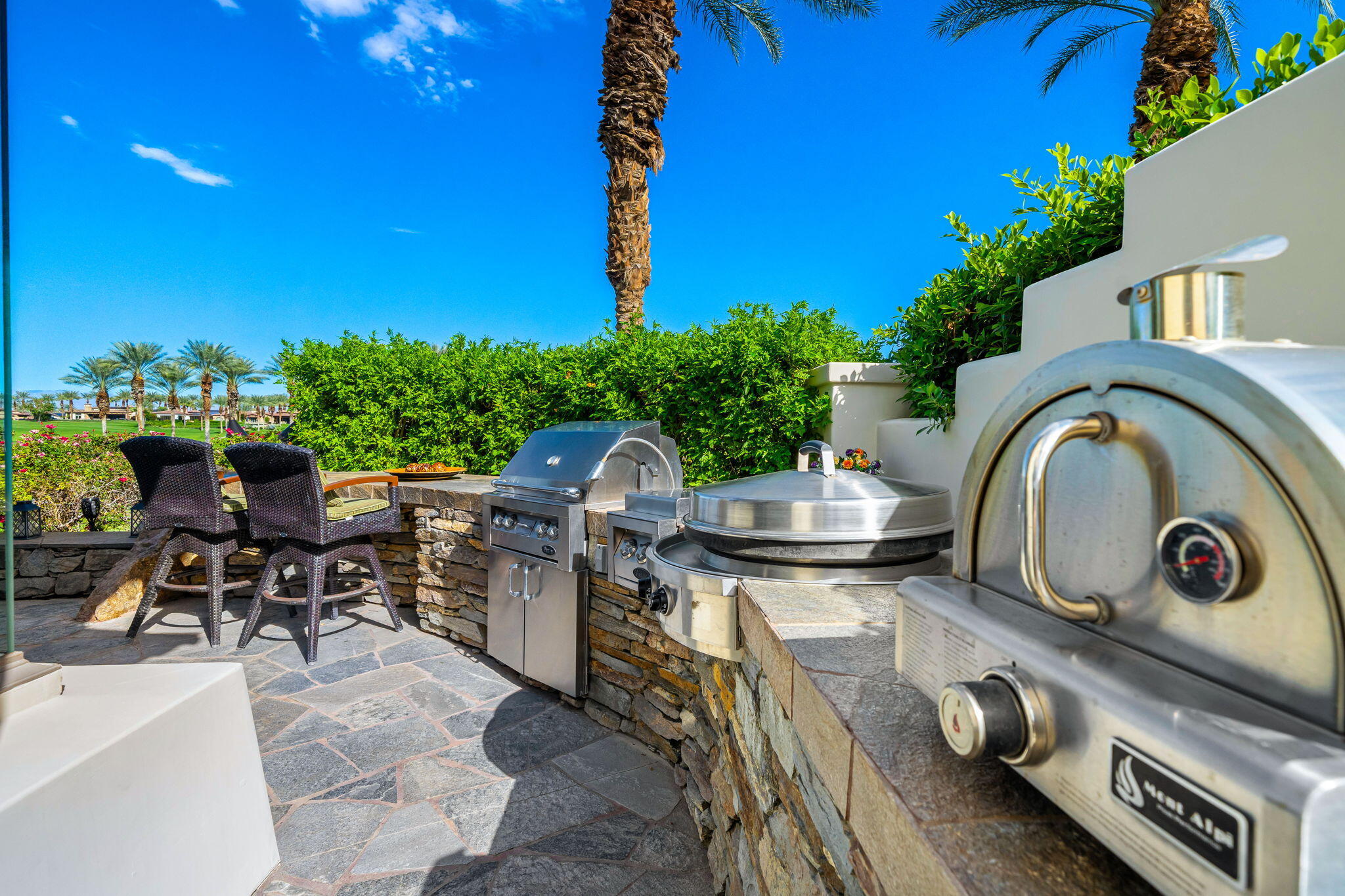 75836 Via Cortona Indian Wells, CA 92210 - Photo 49 of 113 a backyard of a house with table and chairs