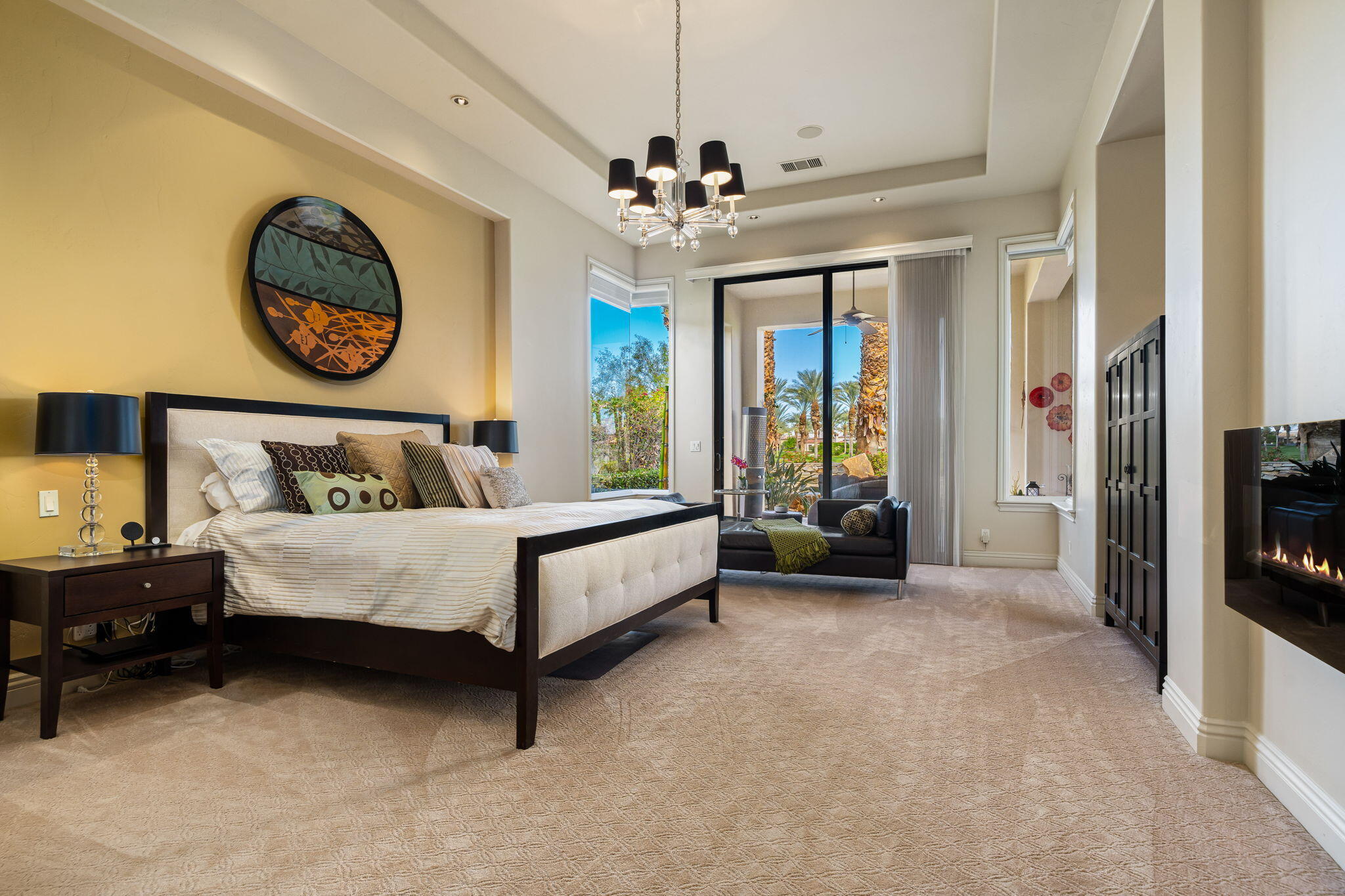 75836 Via Cortona Indian Wells, CA 92210 - Photo 57 of 113 a bed sitting in a spacious bedroom next to a window and a chandelier