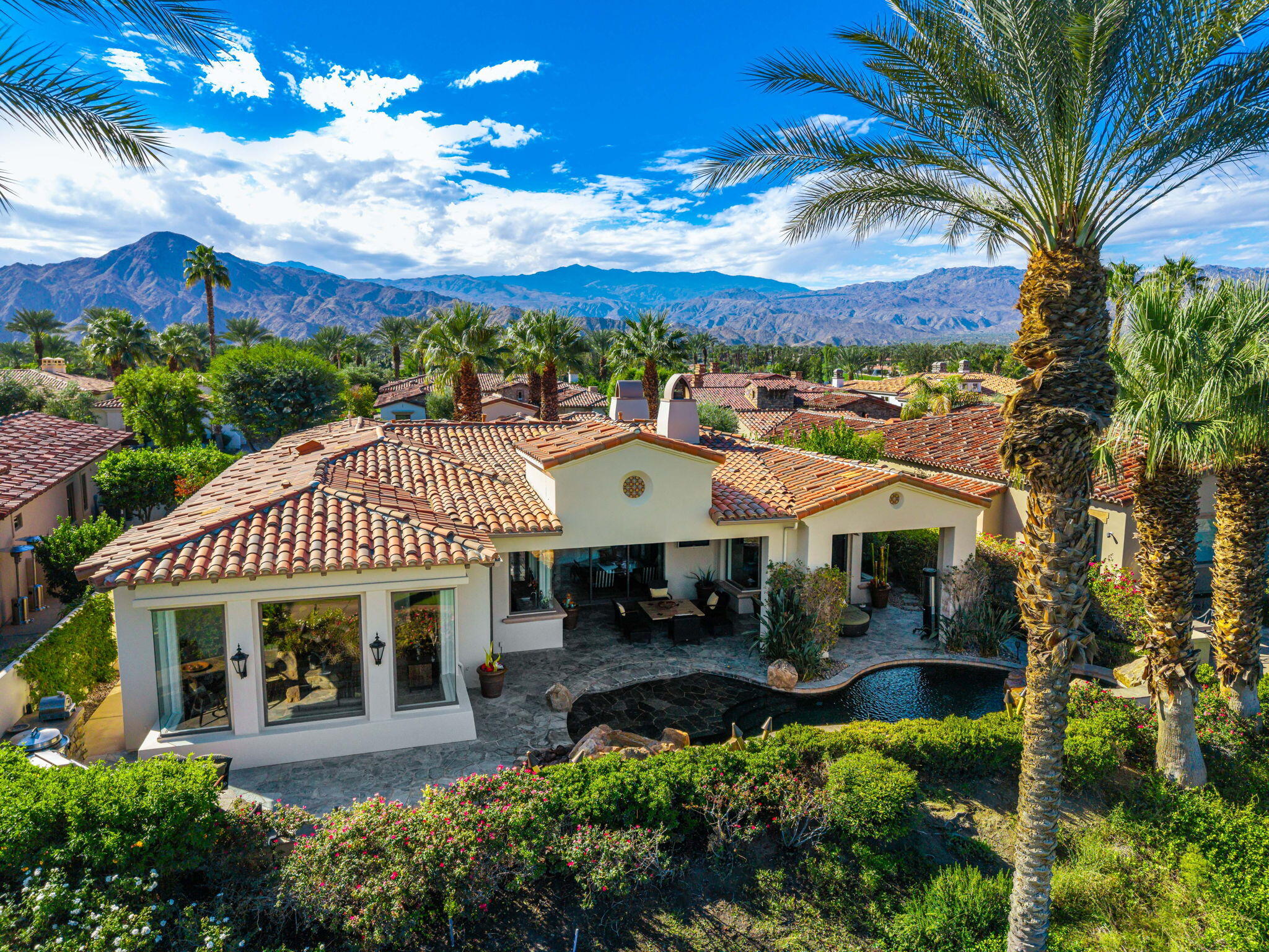75836 Via Cortona Indian Wells, CA 92210 - Photo 6 of 113 a view of a patio with a table and chairs under an umbrella